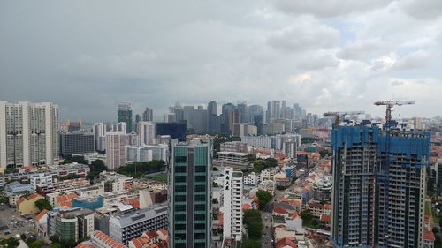 High angle view of modern buildings in city against sky