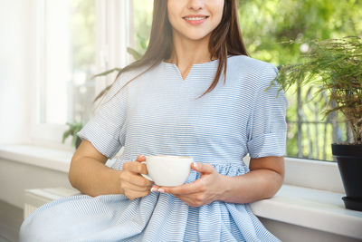 Portrait of young woman using mobile phone