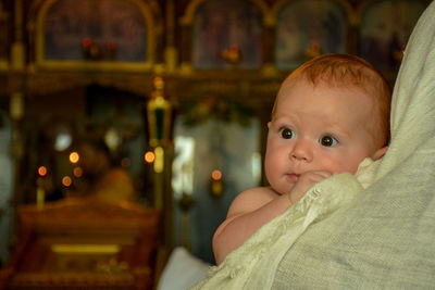 Portrait of cute baby girl looking away