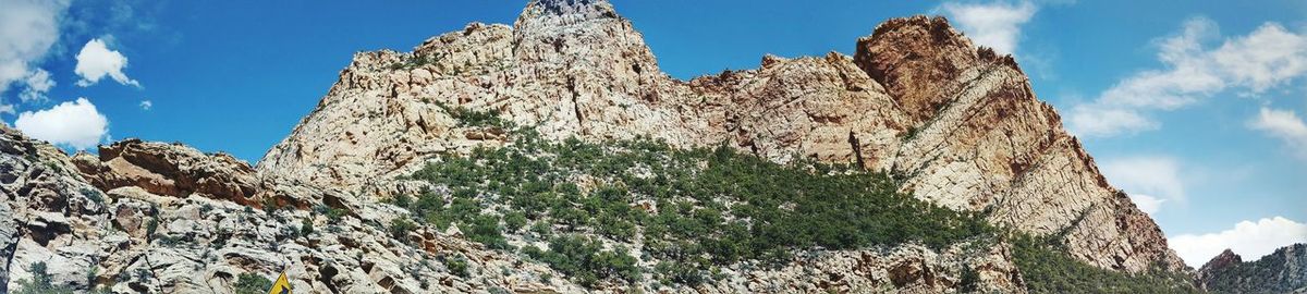 Low angle view of rocky mountain against sky