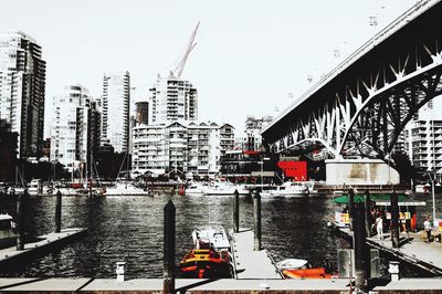 View of boats in river with buildings in background