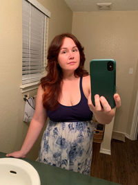 Portrait of young woman using mobile phone