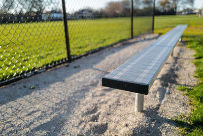 Close-up of empty players bench on baseball field