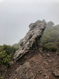 Rock formation on mountain against sky