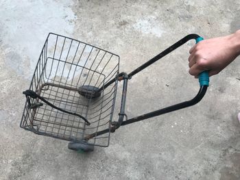 Cropped hand holding shopping cart