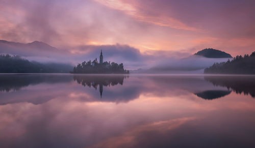 Scenic view of lake against sky during sunset