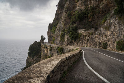 Road by sea against sky