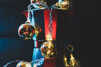 Close-up of illuminated lighting equipment against black background