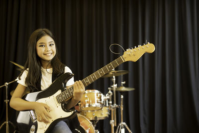 Portrait of girl playing guitar