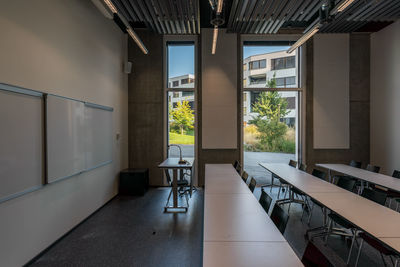 Empty chairs and table in room