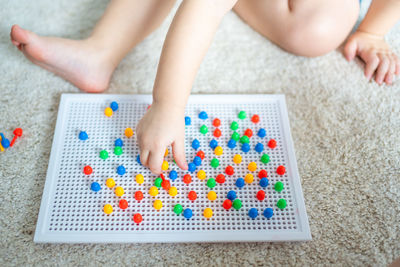 Low section of woman playing with toy blocks