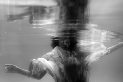 Digital composite image of man swimming in sea