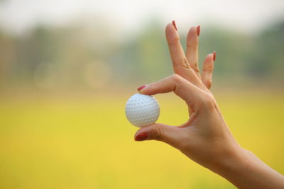 Close-up of woman hand holding ball