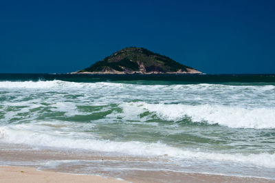 Scenic view of sea against clear blue sky