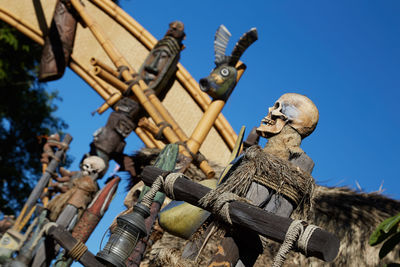 Low angle view of sculpture against blue sky