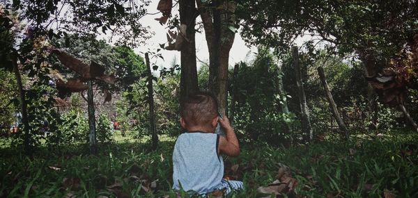 Man photographing through smart phone in forest