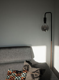 Electric lamp on table against wall at home