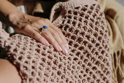 Close-up of woman hand resting on a woven eco tote bag