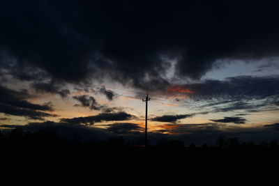 Silhouette of landscape against cloudy sky