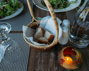 Rustic dinner table with tea light and healthy meal