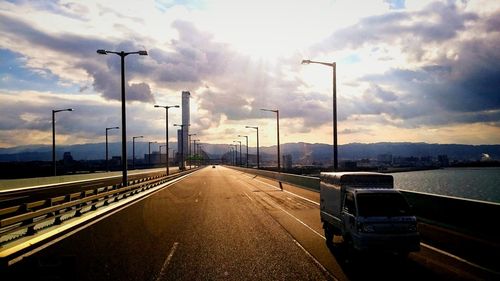 Empty road with mountain range in background