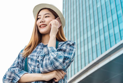 Portrait of smiling young woman looking away