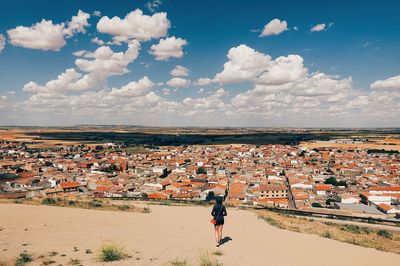 High angle view of woman in town against sky