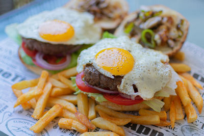 Burger and eye-egg with fries