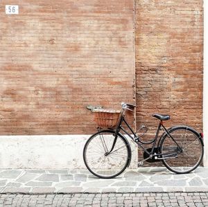 Bicycle parked against wall