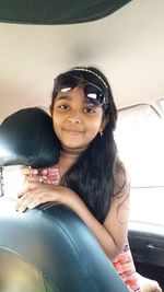 Portrait of smiling young woman sitting at home