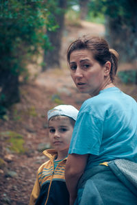 Close-up of father with daughter against trees