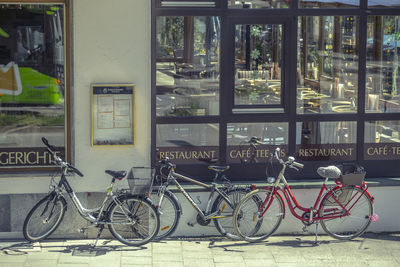 Bicycle parked by railing on street