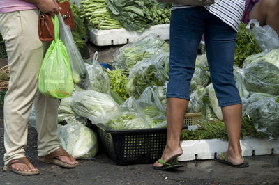 Low section of people buying vegetables