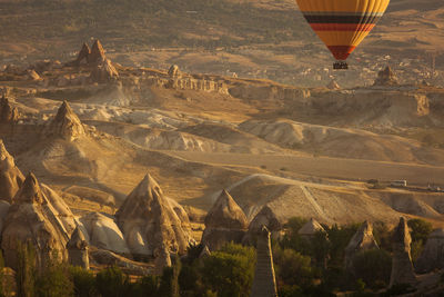 Aerial view of hot air balloon flying over land