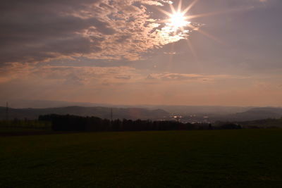 Scenic view of field against sky during sunset