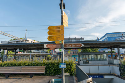 Information sign on road against sky