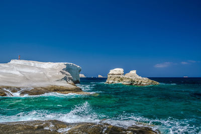 Scenic view of sea against clear blue sky