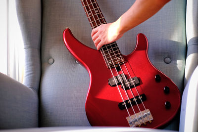 Midsection of man playing guitar