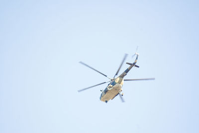 Low angle view of helicopter against clear sky