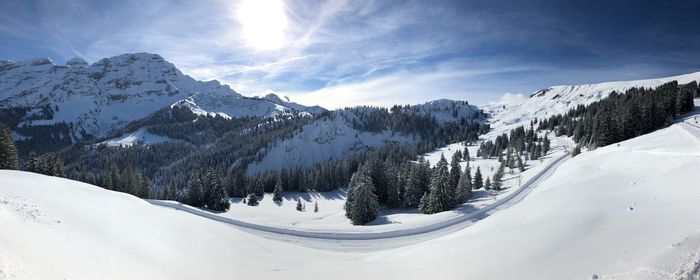 Scenic view of snow covered mountains against sky