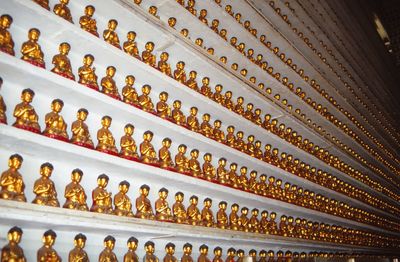 Full frame shot of statues in shelves for sale