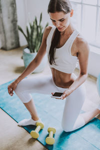 Young woman exercising at home