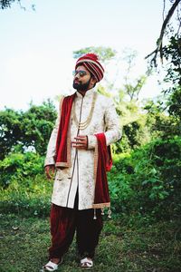 Full length of man standing on field against sky