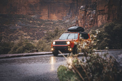 A car is on the rainy road in zion national park, utah