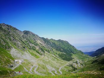 Scenic view of mountains against clear blue sky