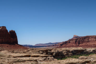 Scenic view of barren rock hills against clear sky