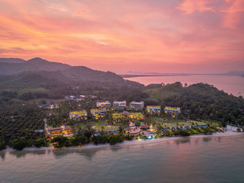 High angle view of townscape by river against sky during sunset