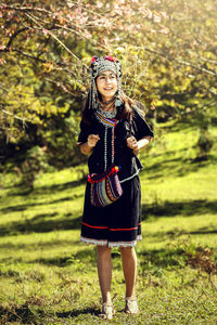 Full length of girl standing on grass