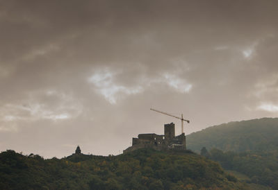 Low angle view of mountains against cloudy sky