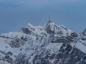 Low angle view of snowcapped mountains against clear sky